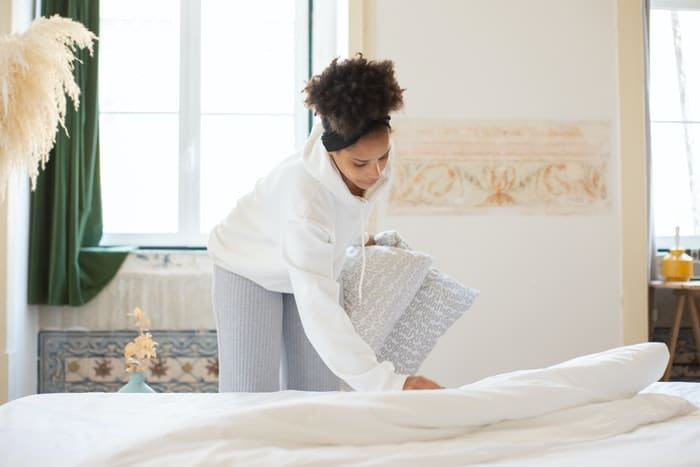woman making bed woman making bed