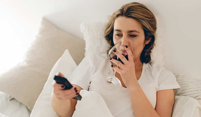 Drinking Wine In Bed On Phone