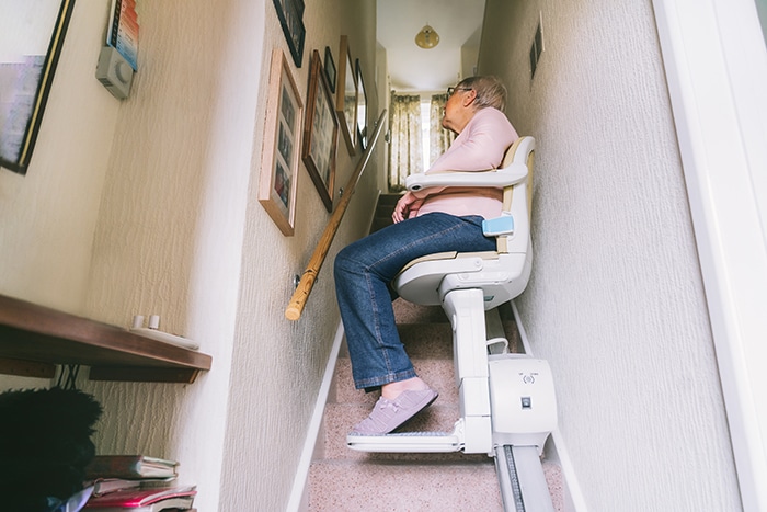 Senior Woman Using Stair Lift